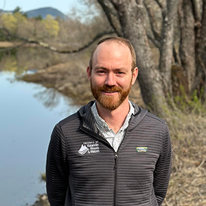 Brian Hinrichs stands by the East Branch of the Penobscot River near Lunksoos Camps