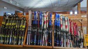 A large rack full of colorful skis.