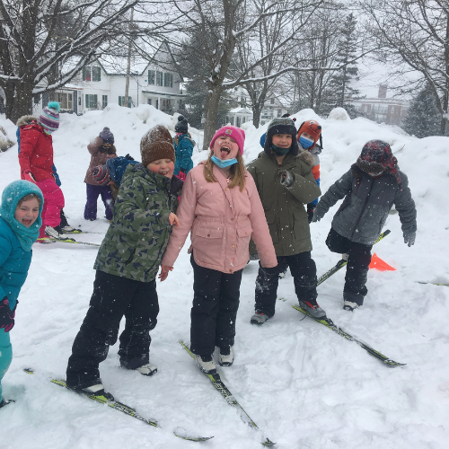 Children laughing outside in the snow